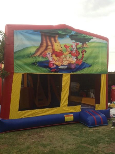 Hire WINNIE THE POOH JUMPING CASTLE WITH SLIDE